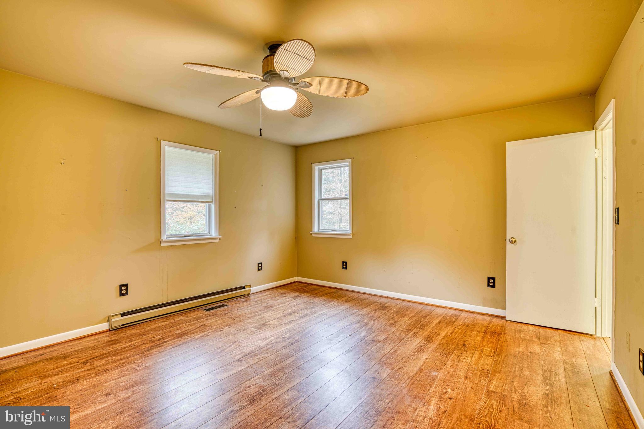14957 Cherry Lane Ridgely, MD 21660 - Photo 27 of 66 a view of an empty room with wooden floor and a window