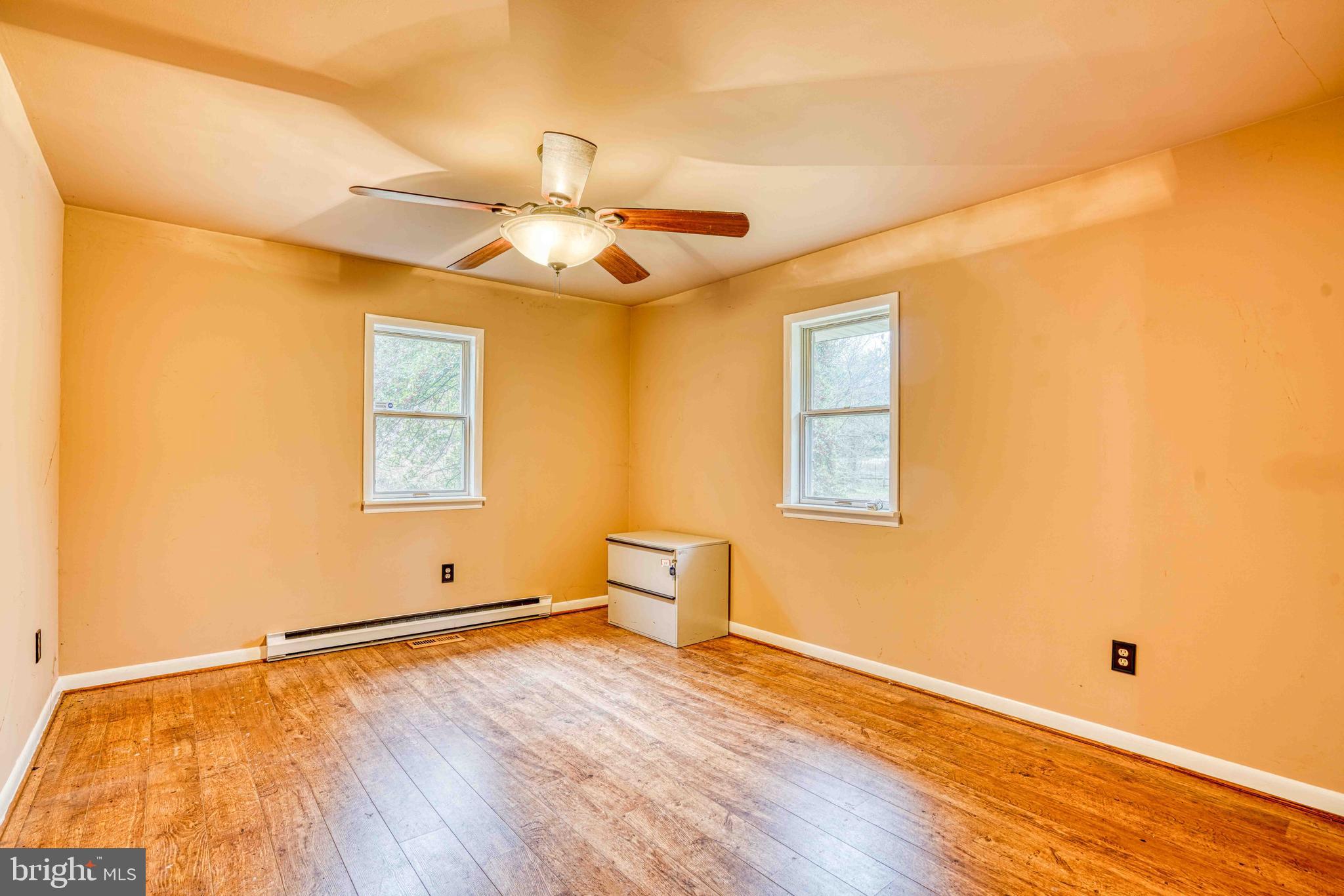 14957 Cherry Lane Ridgely, MD 21660 - Photo 28 of 66 a view of empty room with wooden floor and fan