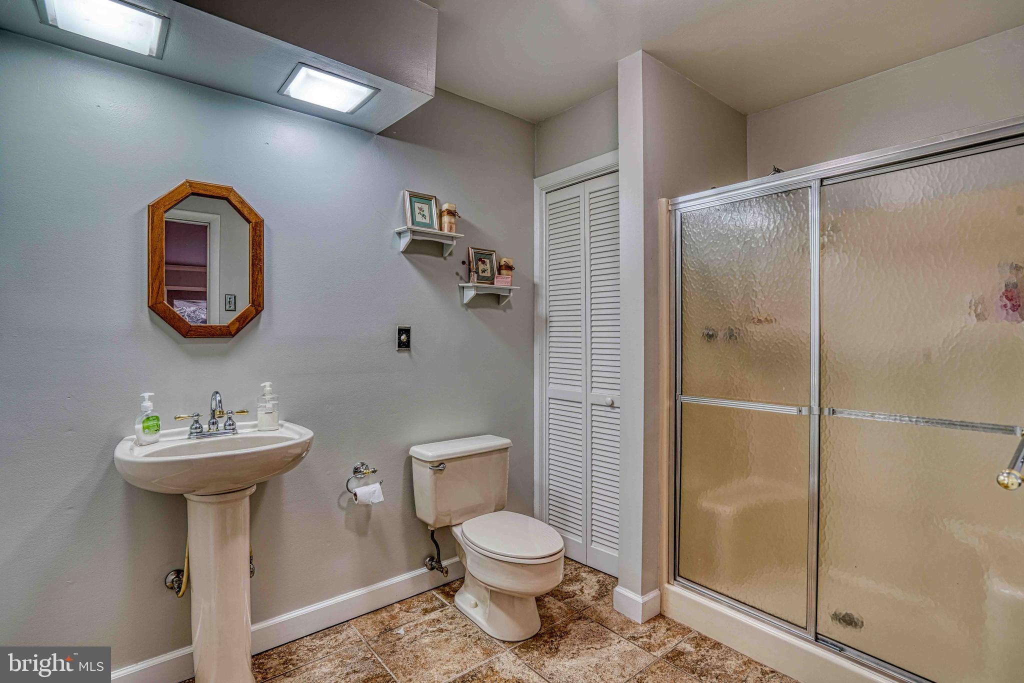 14957 Cherry Lane Ridgely, MD 21660 - Photo 32 of 66 a bathroom with a toilet sink and shower