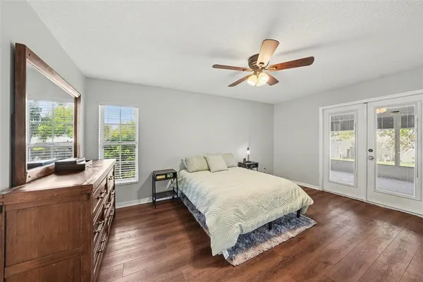 a bedroom with a bed and wooden floor