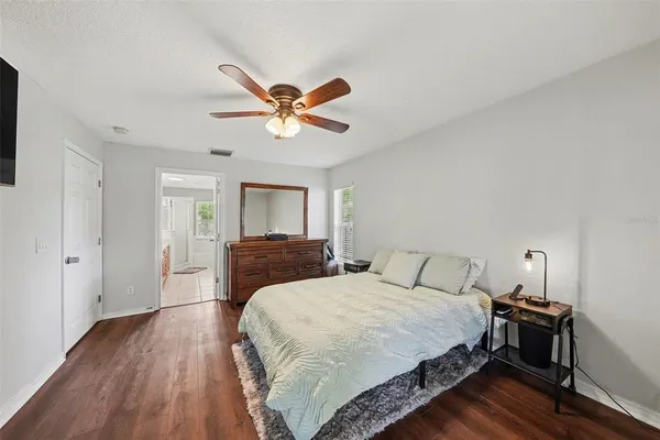 a bedroom with a bed and wooden floor