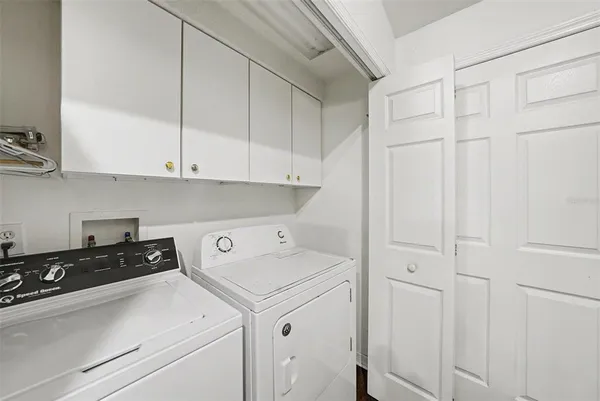 a view of a storage and utility room with washer and dryer