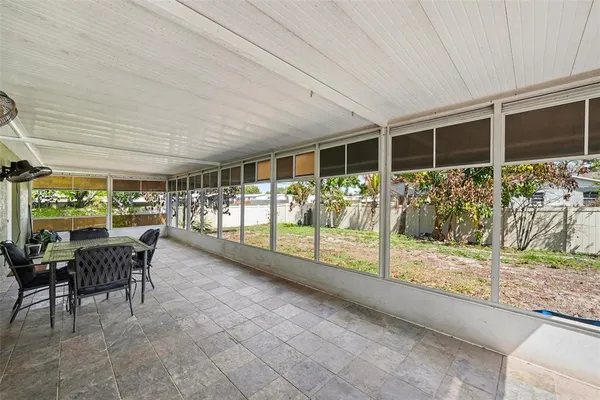 a view of a porch with furniture and garden