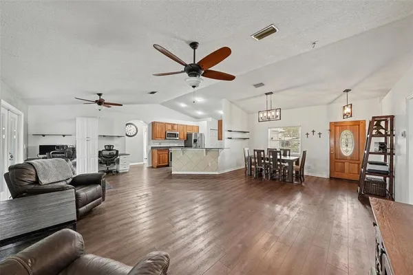 a living room with furniture and kitchen view