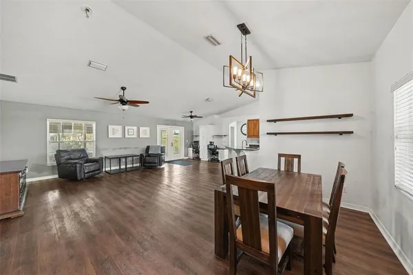 a view of a dining room with furniture wooden floor and chandelier