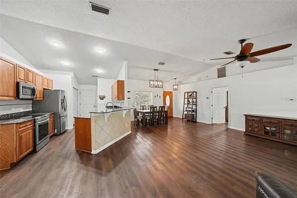 a view of kitchen with cabinets and wooden floor