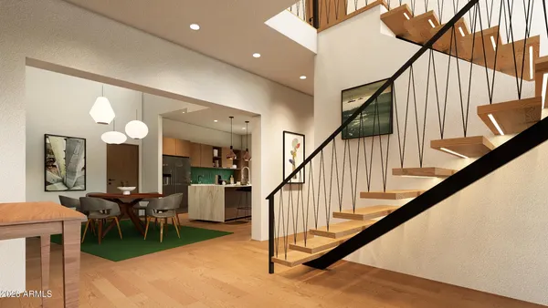 a view of a livingroom with furniture stairs and a chandelier fan