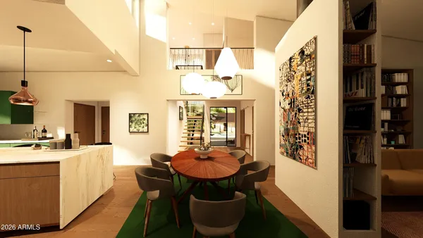 a room with stainless steel appliances a table chairs and a refrigerator