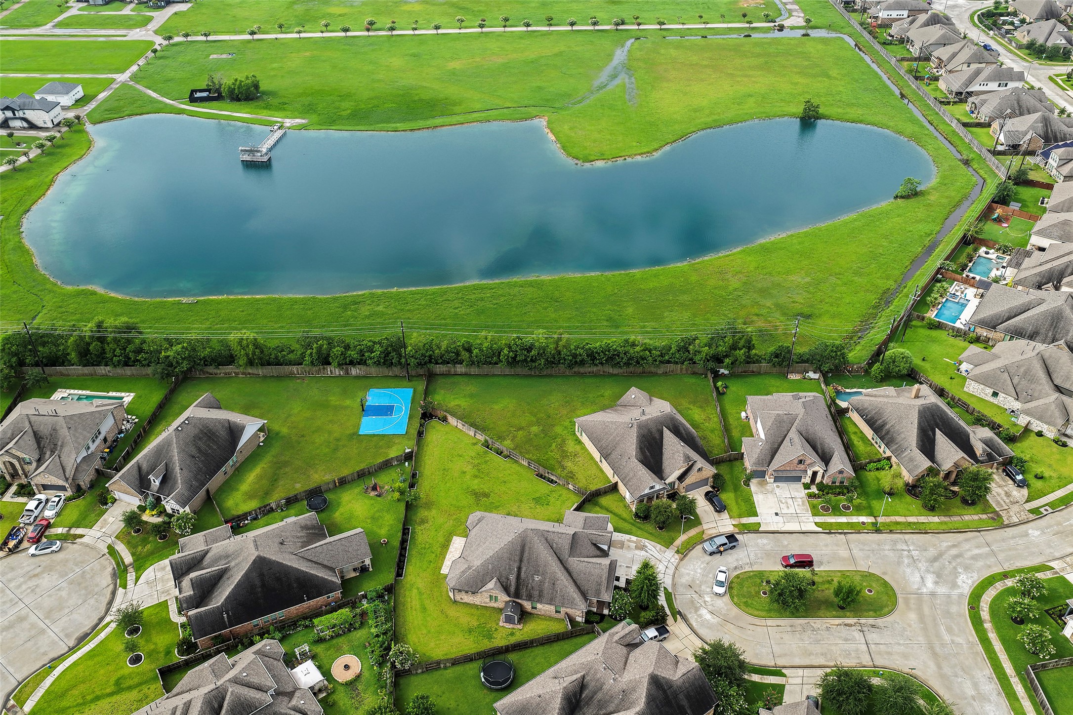 20330 Rosegold Way Spring, TX 77379 - Photo 16 of 48 Drone view highlighting the home's location near neighborhood green space, walking trails, and lake amenities.