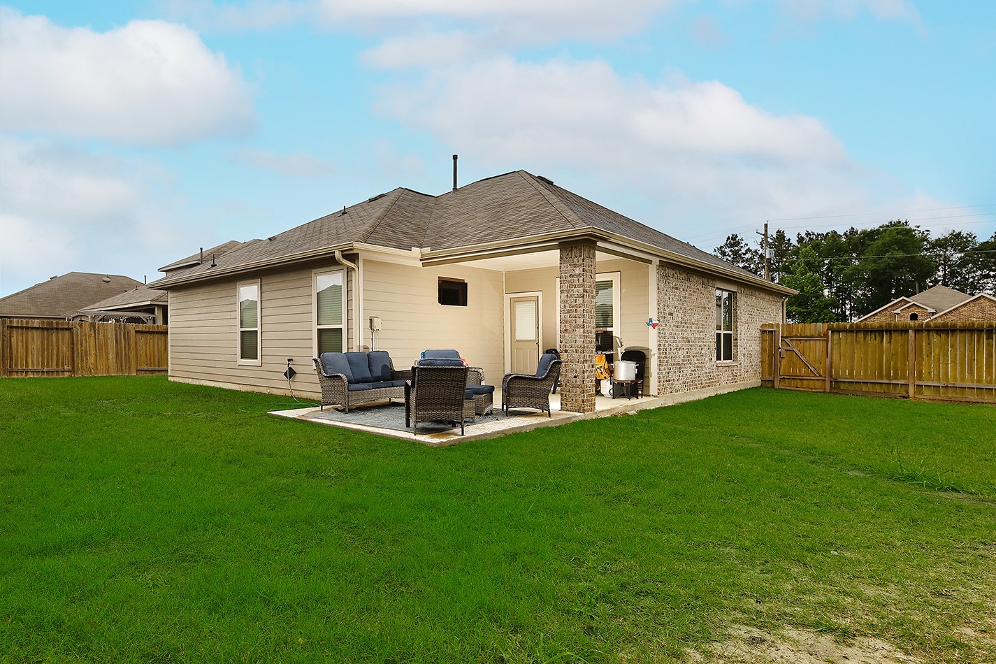 26324 Cooperstown Way Splendora, TX 77372 - Photo 19 of 23 a view of a patio with table and chairs near a big yard