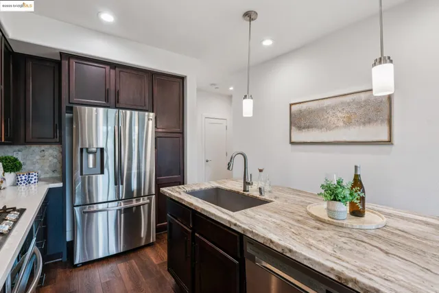 a kitchen with granite countertop a stove and a sink