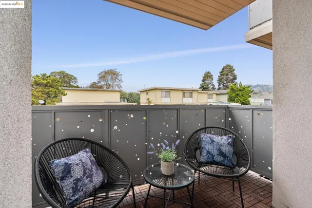 a balcony with furniture and flowers