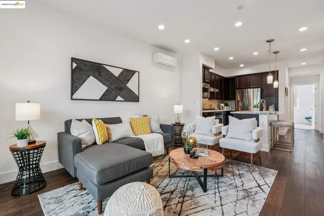 a kitchen with stainless steel appliances kitchen island granite countertop a refrigerator a sink and a stove