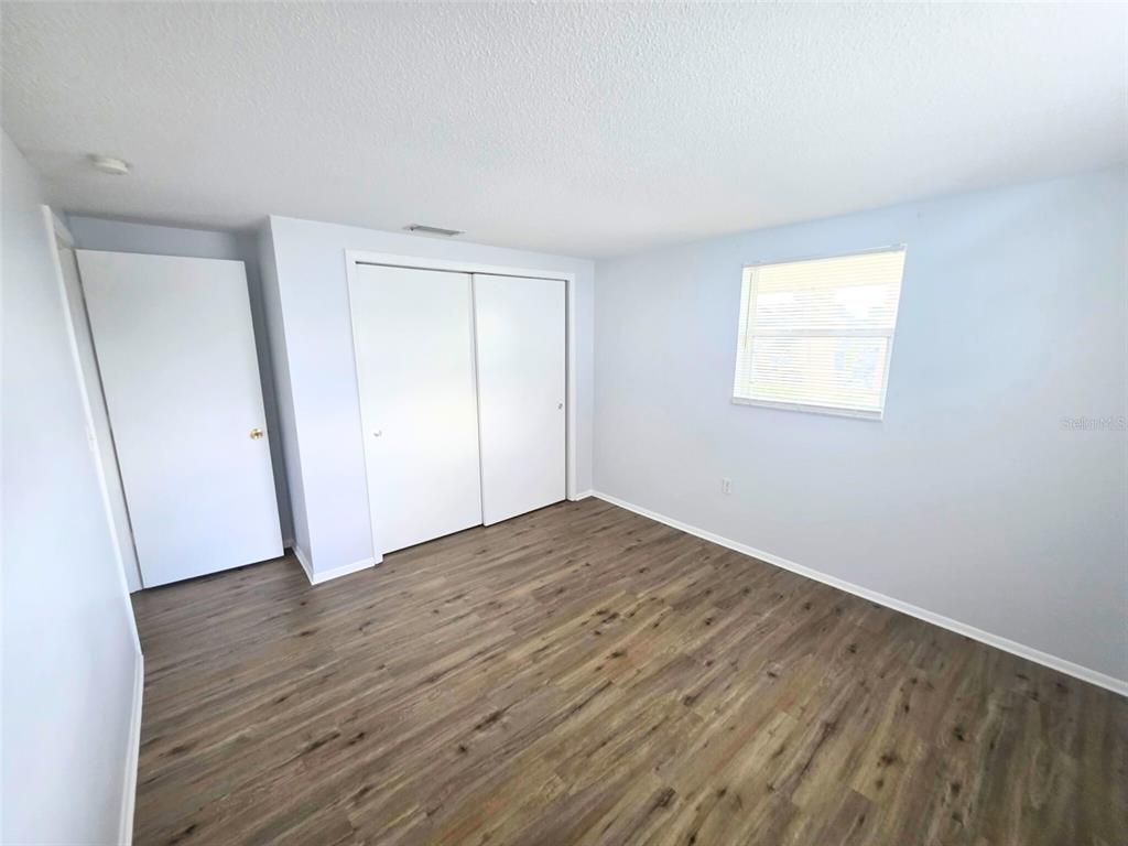 546 Briarwood Road Venice, FL 34293 - Photo 11 of 20 an empty room with wooden floor and closet