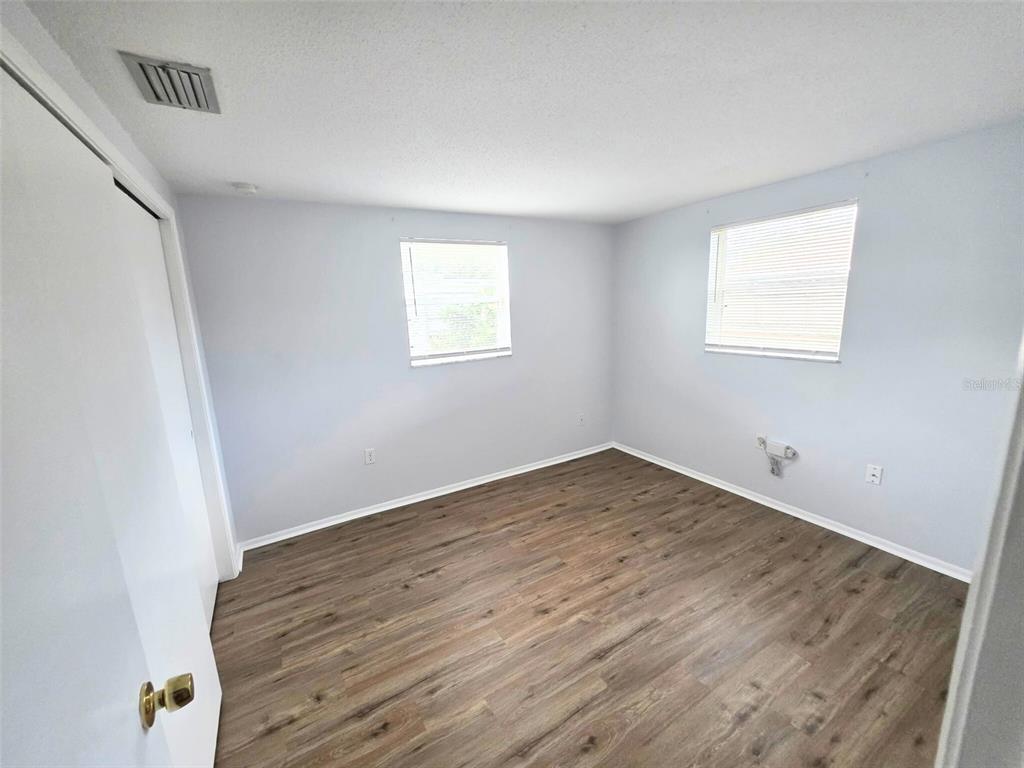 546 Briarwood Road Venice, FL 34293 - Photo 12 of 20 a view of empty room with wooden floor