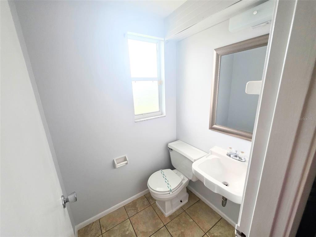 546 Briarwood Road Venice, FL 34293 - Photo 16 of 20 a bathroom with a toilet a sink and a mirror