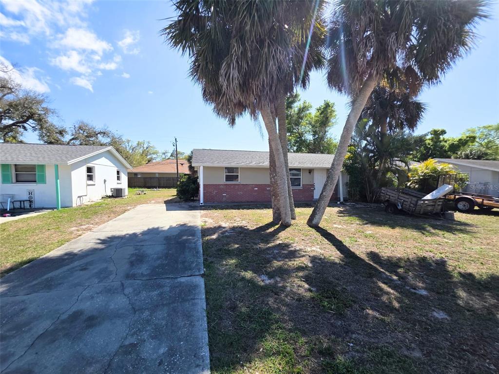 546 Briarwood Road Venice, FL 34293 - Photo 2 of 20 a view of yard with swimming pool and trees