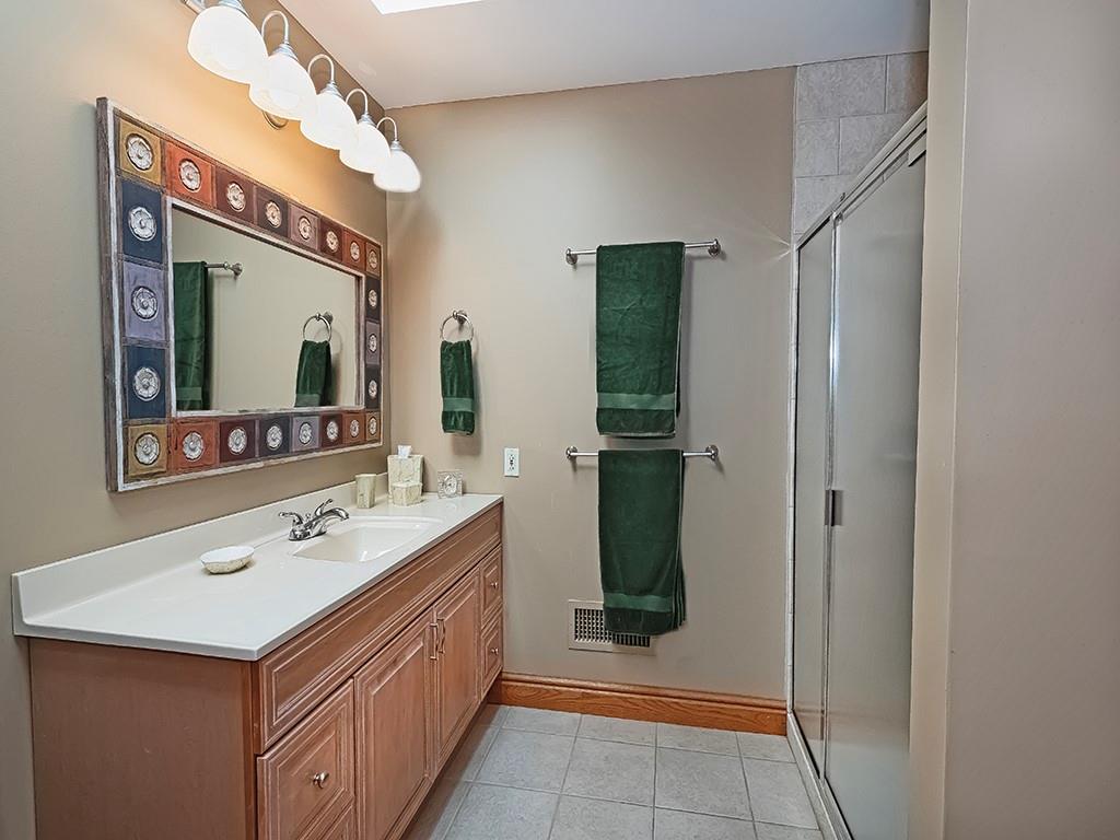 166 McKay Road Saxonburg, PA 16056 - Photo 32 of 48 a bathroom with a sink a mirror and a shower