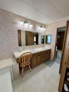 a spacious bedroom with a bed and a mirror