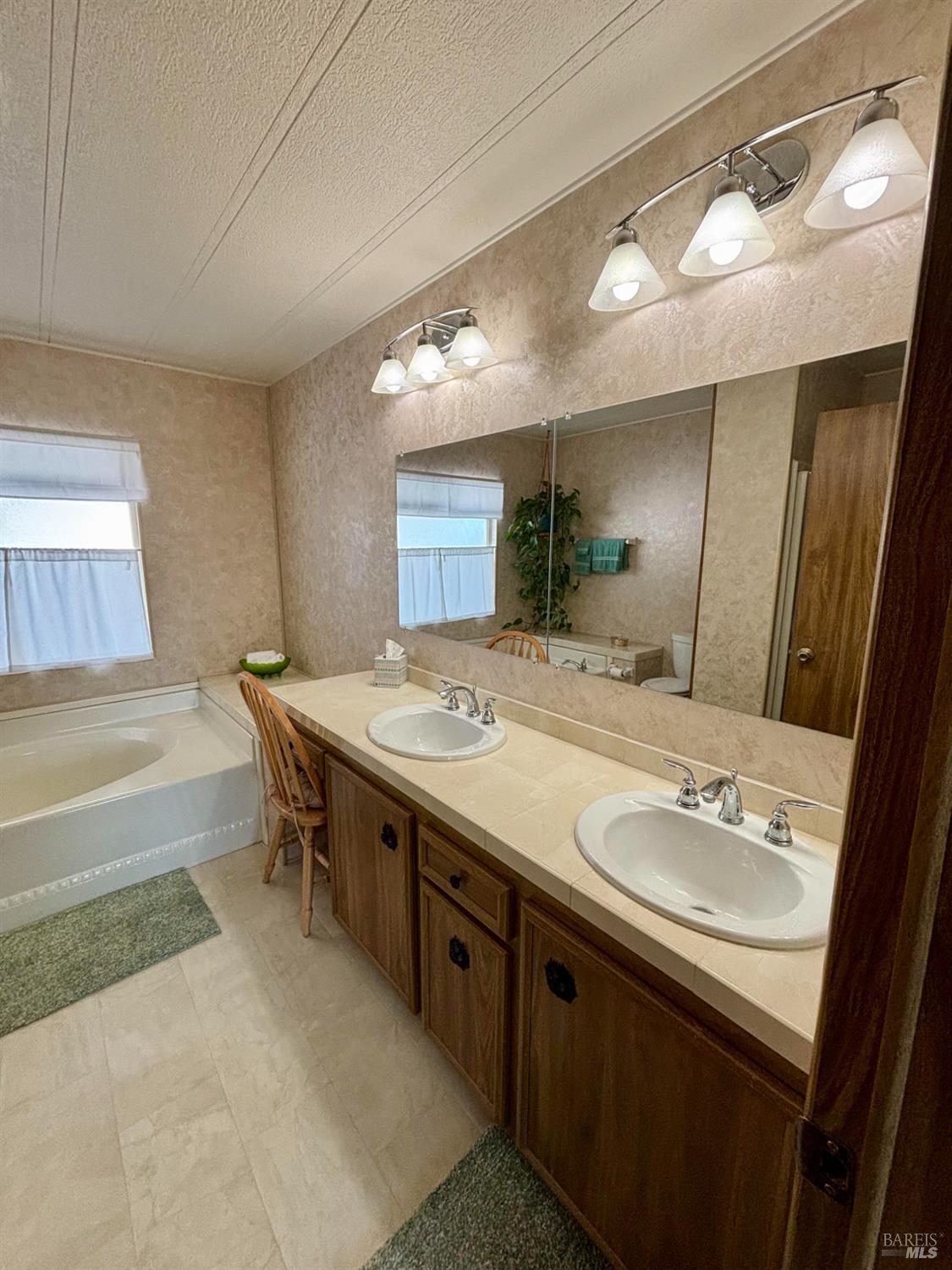 109 Estrella Drive Santa Rosa, CA 95403 - Photo 13 of 22 a spacious bathroom with a sink a large mirror and a bath tub