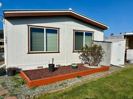 a front view of house with yard and outdoor seating