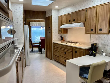 a kitchen with a stove a sink and cabinets