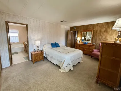 a bedroom with bed and window