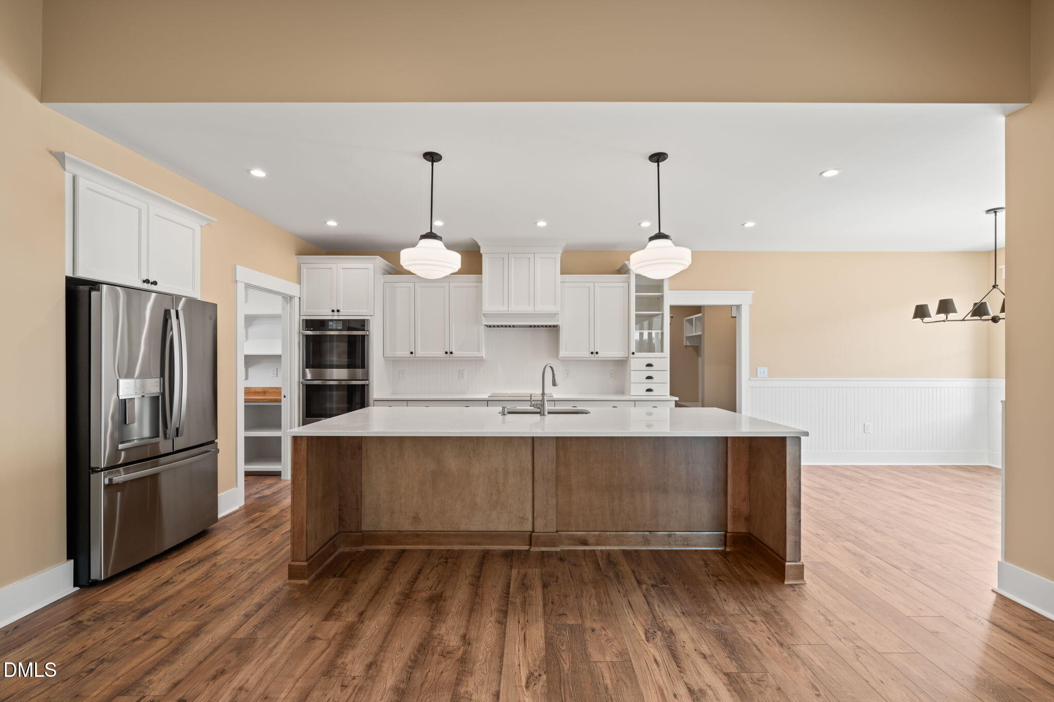 13887 Burgess Road Middlesex, NC 27557 - Photo 11 of 45 a large kitchen with granite countertop a stove refrigerator and wooden floor