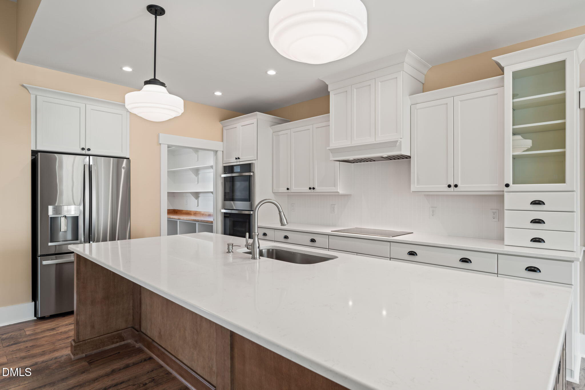13887 Burgess Road Middlesex, NC 27557 - Photo 12 of 45 a kitchen with kitchen island white cabinets and stainless steel appliances