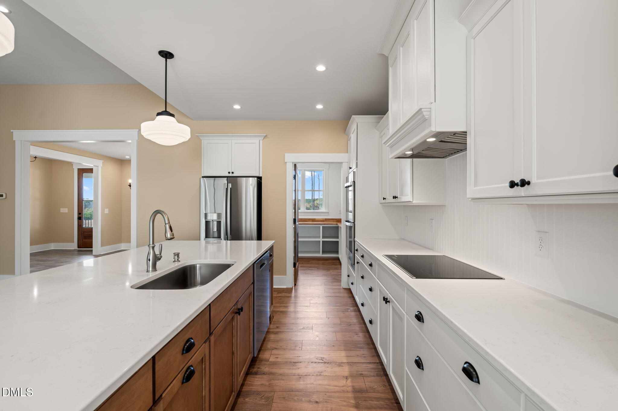 13887 Burgess Road Middlesex, NC 27557 - Photo 13 of 45 a large kitchen with stainless steel appliances lots of counter space and wooden floors