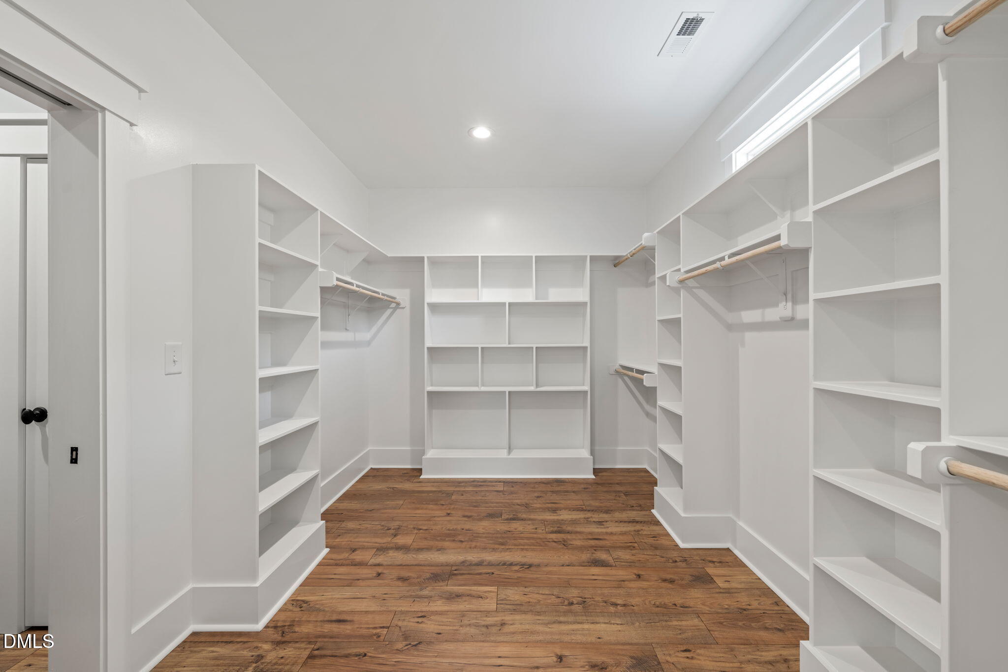 13887 Burgess Road Middlesex, NC 27557 - Photo 23 of 45 a room with a closet and wooden shelves