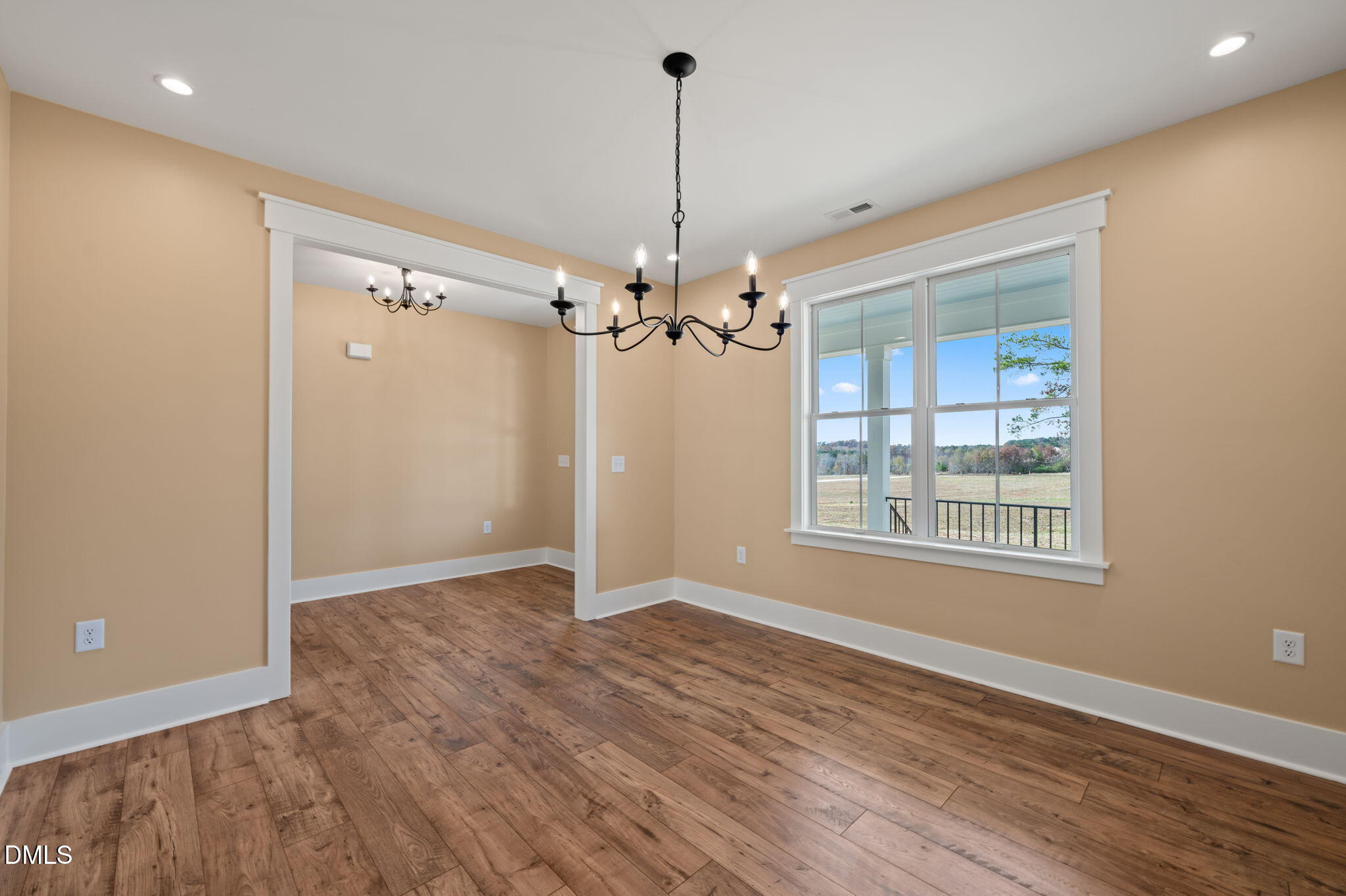 13887 Burgess Road Middlesex, NC 27557 - Photo 6 of 45 a view of an empty room with chandelier and window