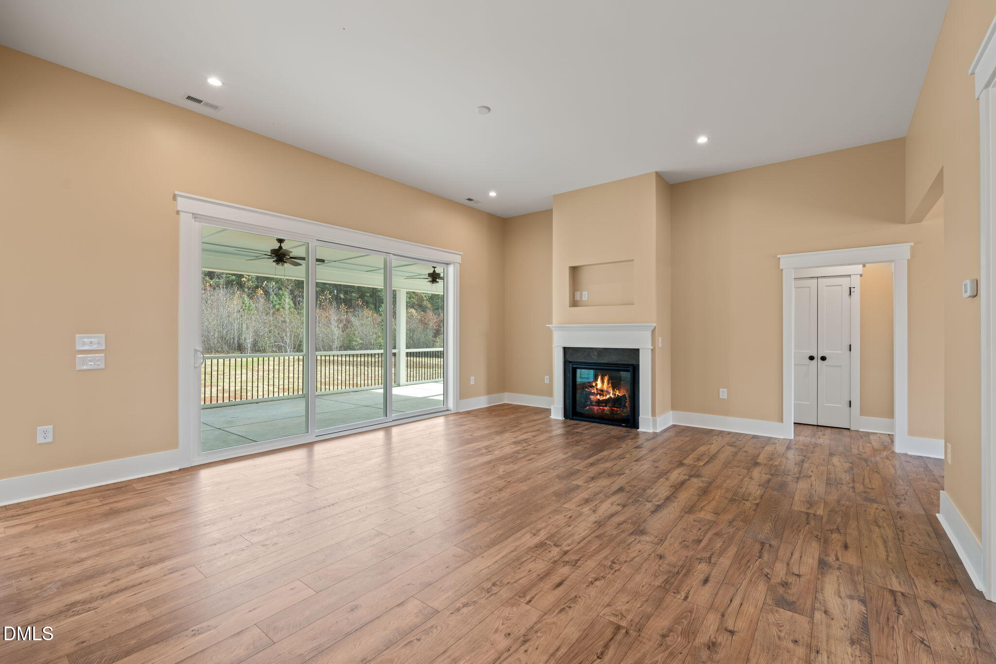 13887 Burgess Road Middlesex, NC 27557 - Photo 8 of 45 a view of an empty room with wooden floor and a window