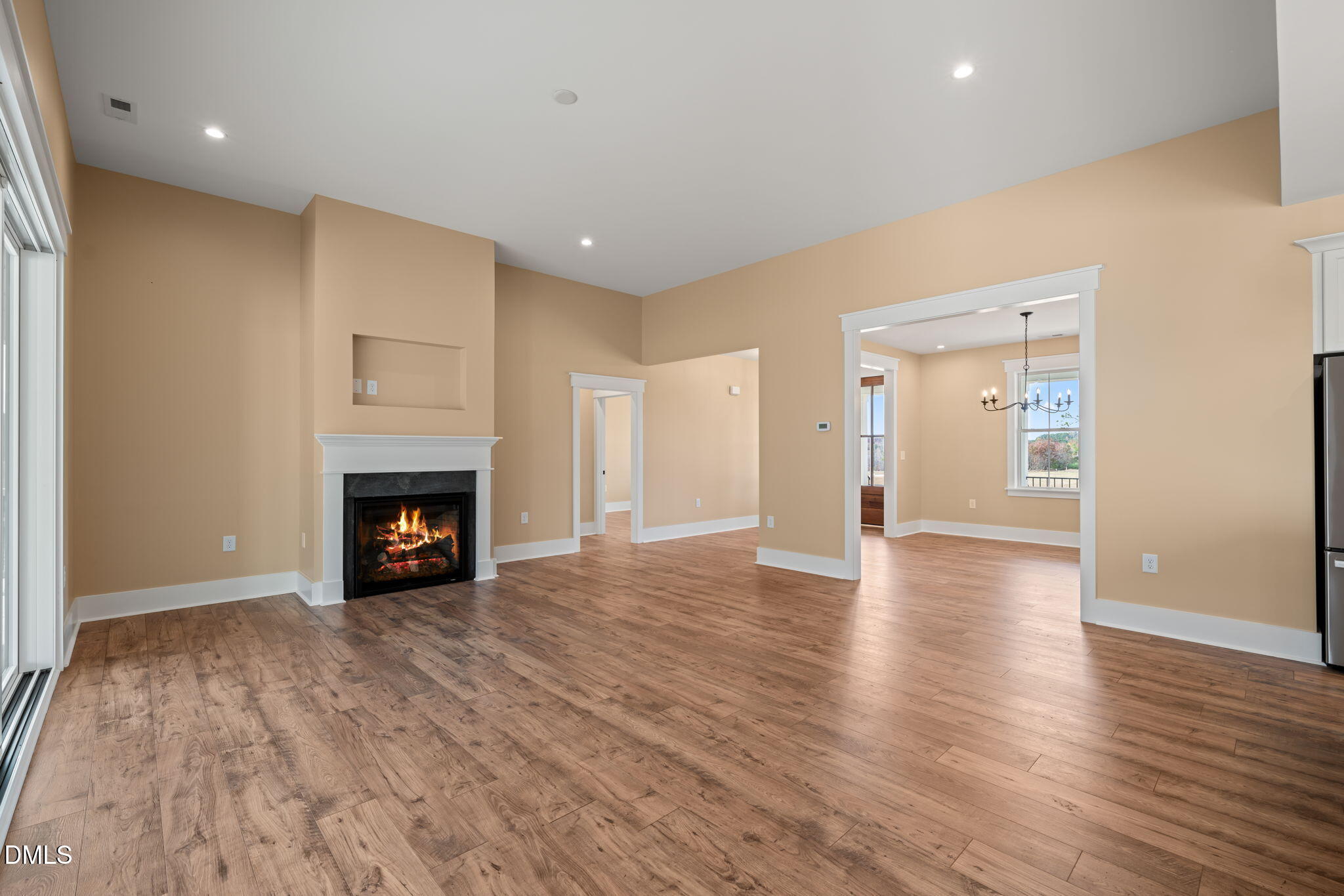 13887 Burgess Road Middlesex, NC 27557 - Photo 9 of 45 a view of an empty room with wooden floor fireplace and a window