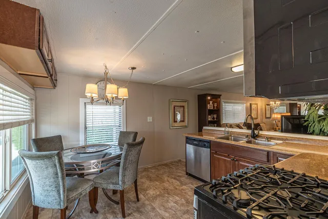a bedroom with a large bed and a potted plant on the dresser