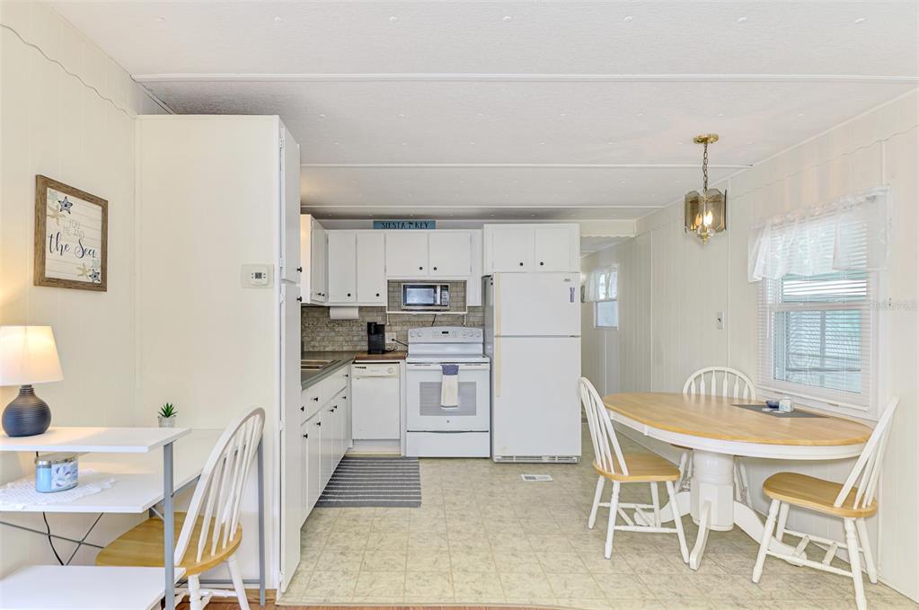 259 Inner Drive East Venice, FL 34285 - Photo 12 of 26 a kitchen with white cabinets and stainless steel appliances
