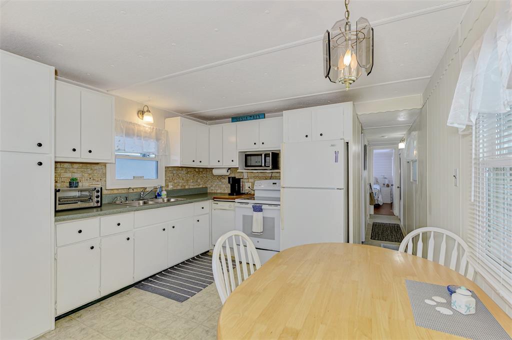 259 Inner Drive East Venice, FL 34285 - Photo 13 of 26 a kitchen with granite countertop white cabinets and stainless steel appliances
