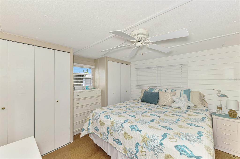 259 Inner Drive East Venice, FL 34285 - Photo 14 of 26 a bedroom with a large bed and a chandelier