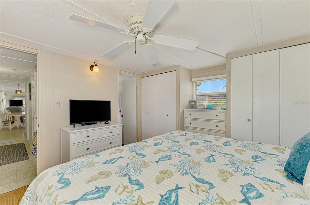259 Inner Drive East Venice, FL 34285 - Photo 15 of 26 a bedroom with a bed window and a flat screen tv