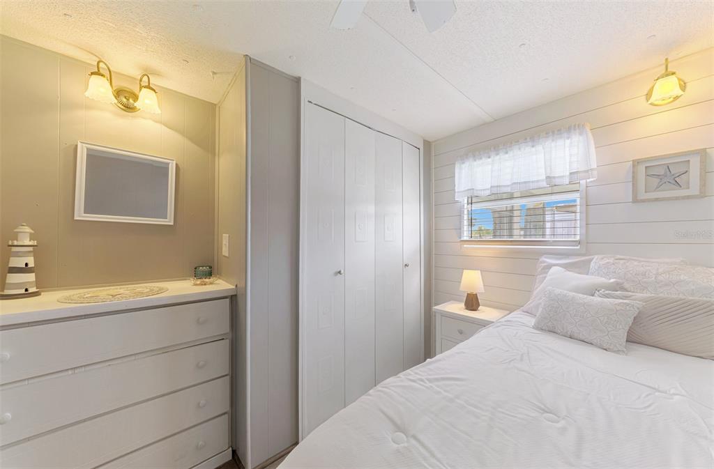 259 Inner Drive East Venice, FL 34285 - Photo 19 of 26 a bedroom with a bed and a cabinets