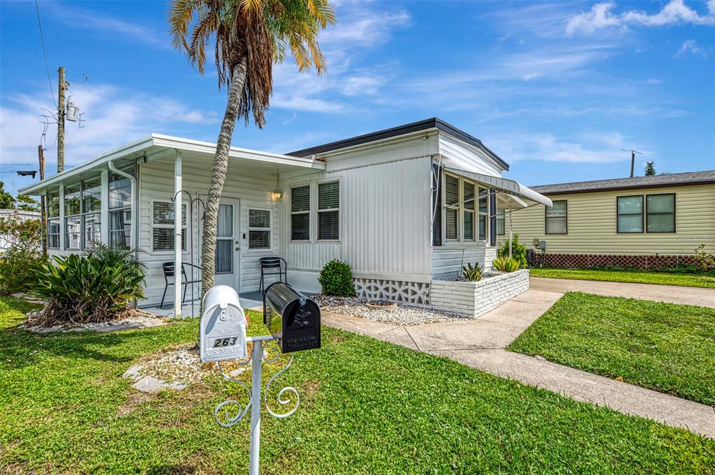 259 Inner Drive East Venice, FL 34285 - Photo 2 of 26 a front view of a house with garden