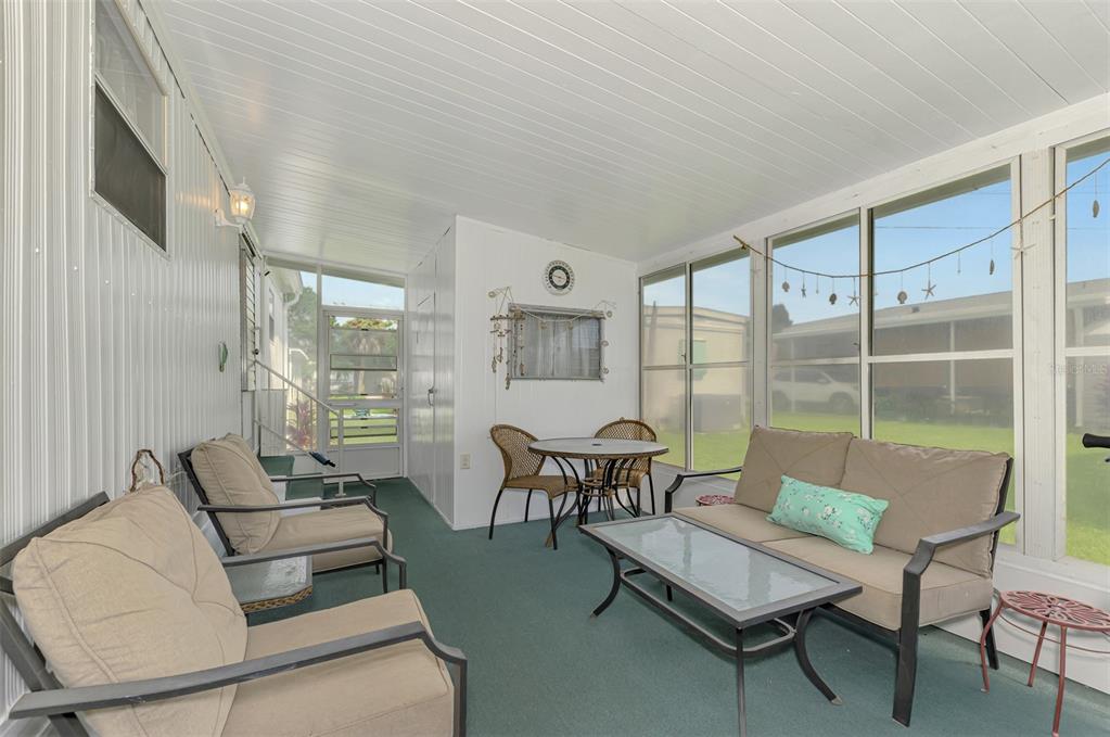 259 Inner Drive East Venice, FL 34285 - Photo 5 of 26 a living room with furniture and a floor to ceiling window
