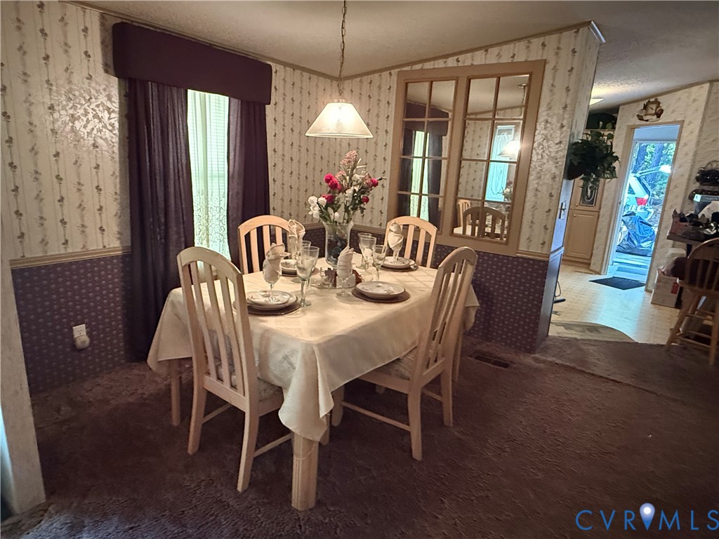 1370 Dorrell Road Aylett, VA 23009 - Photo 2 of 8 a dining room with furniture a chandelier and window
