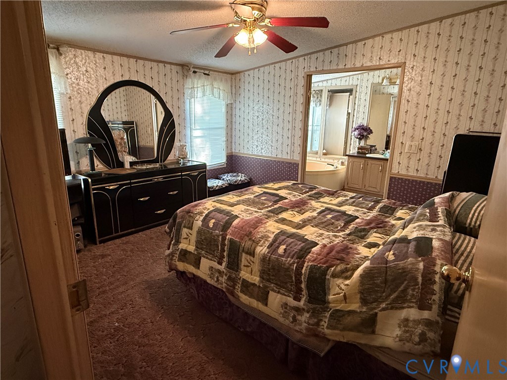 1370 Dorrell Road Aylett, VA 23009 - Photo 5 of 8 a bedroom with a bed and a mirror on dresser