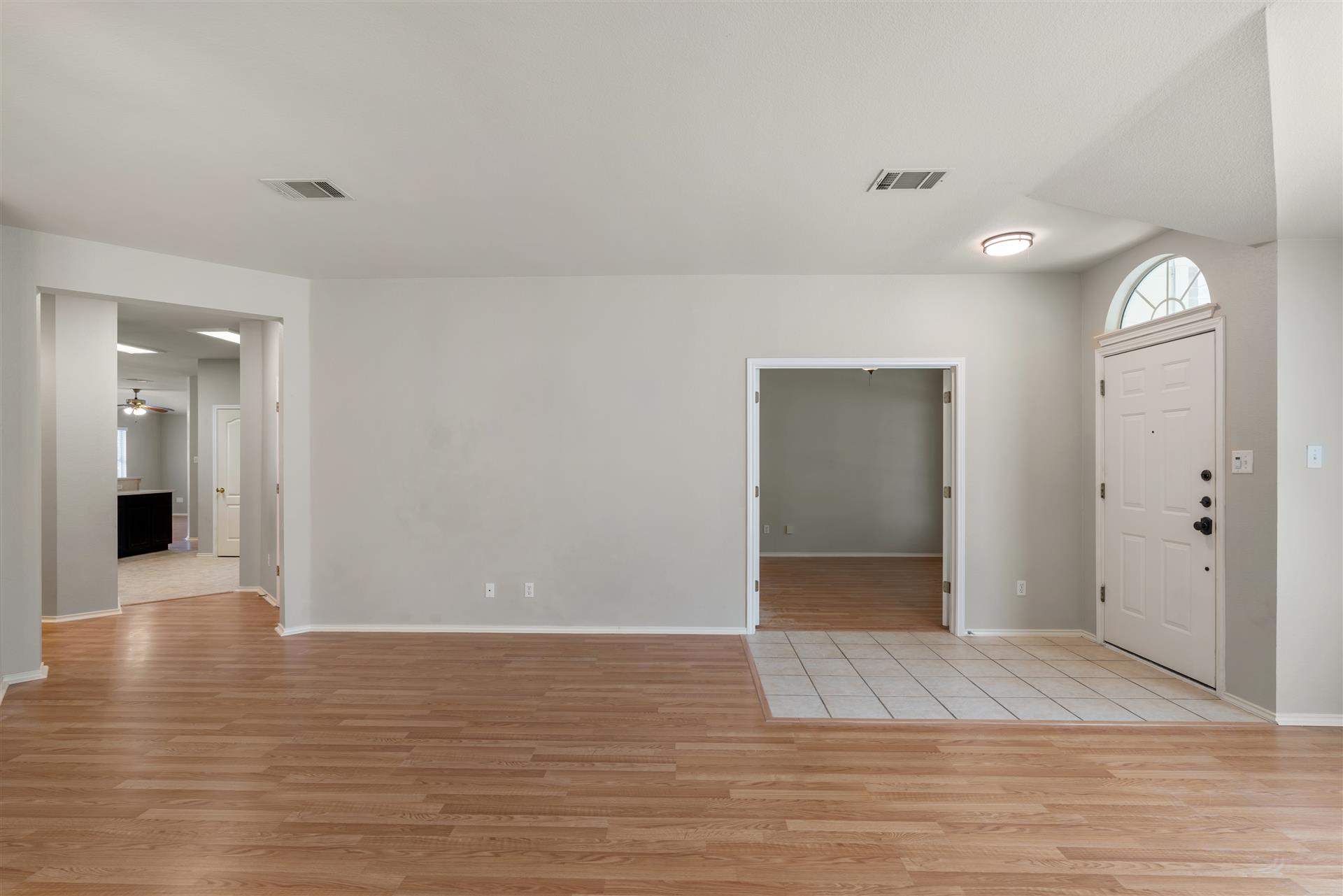 4725 Tello Path Austin, TX 78749 - Photo 9 of 34 Laminate flooring flows throughout this adaptable living space with a distinct tile entry.