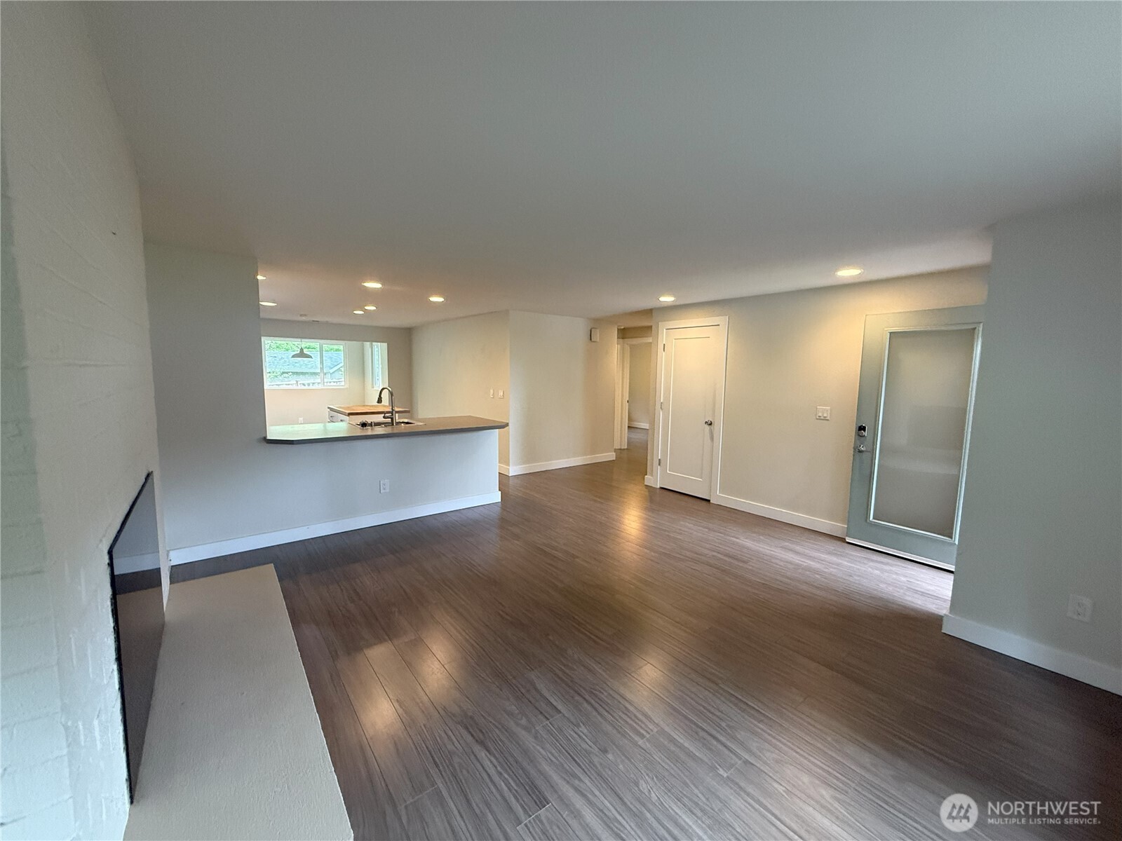 8820 Prentice Avenue Gig Harbor, WA 98332 - Photo 7 of 13 a view of a big room with wooden floor and a kitchen