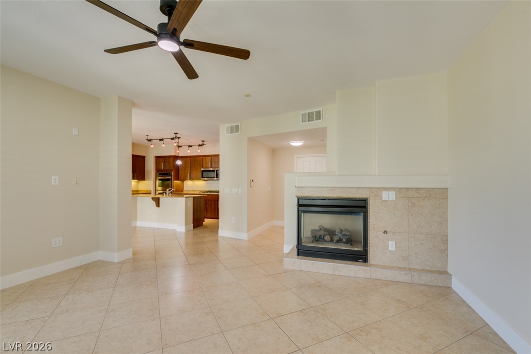 2555 Hampton Road, Unit 3203 Henderson, NV 89052 - Photo 16 of 43 Tiled flooring and a modern fireplace define this open and welcoming living space.