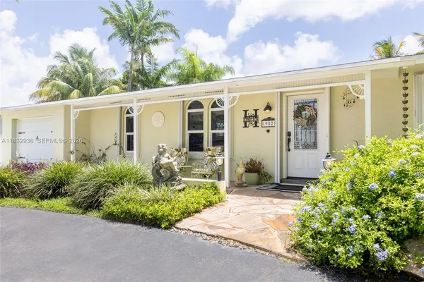 a front view of a house with garden