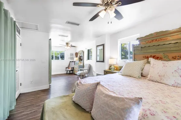 a spacious bedroom with a bed and ceiling fan