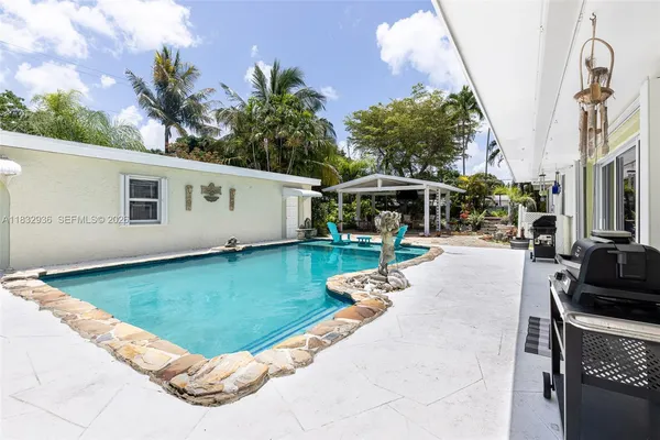 a view of a house with backyard porch and sitting area